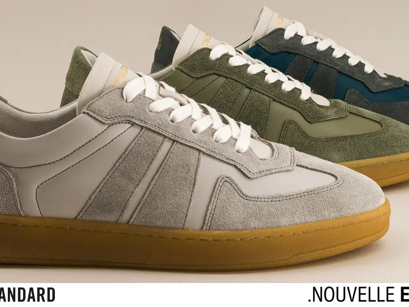 National Standard Edition 33 premium suede sneakers in gray, green, and blue with gum soles.