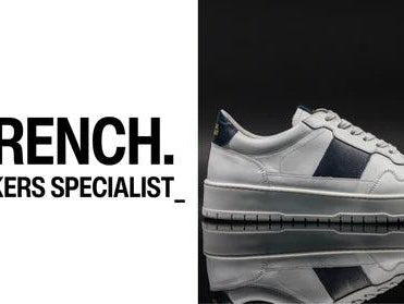 National Standard white sneaker on black background with #FRENCH. Sneakers Specialist text