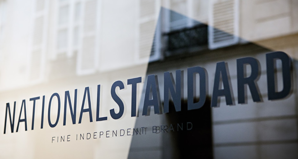 National Standard logo and fine independent brand text on a shop window in natural light
