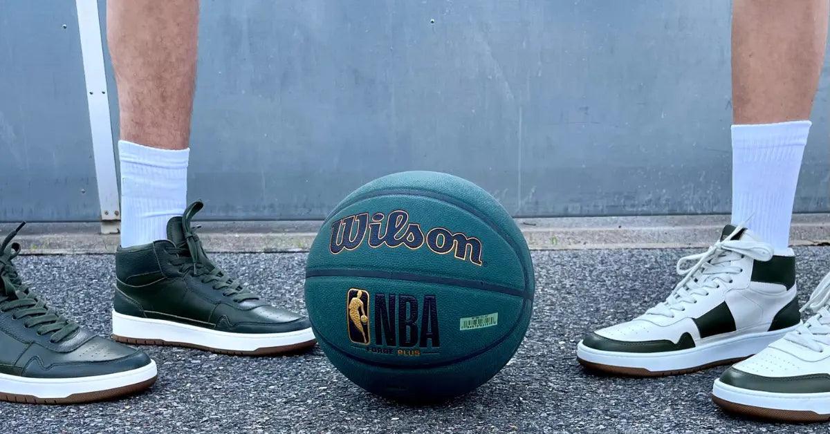 National Standard premium sneakers in green and white beside NBA Wilson basketball outdoors