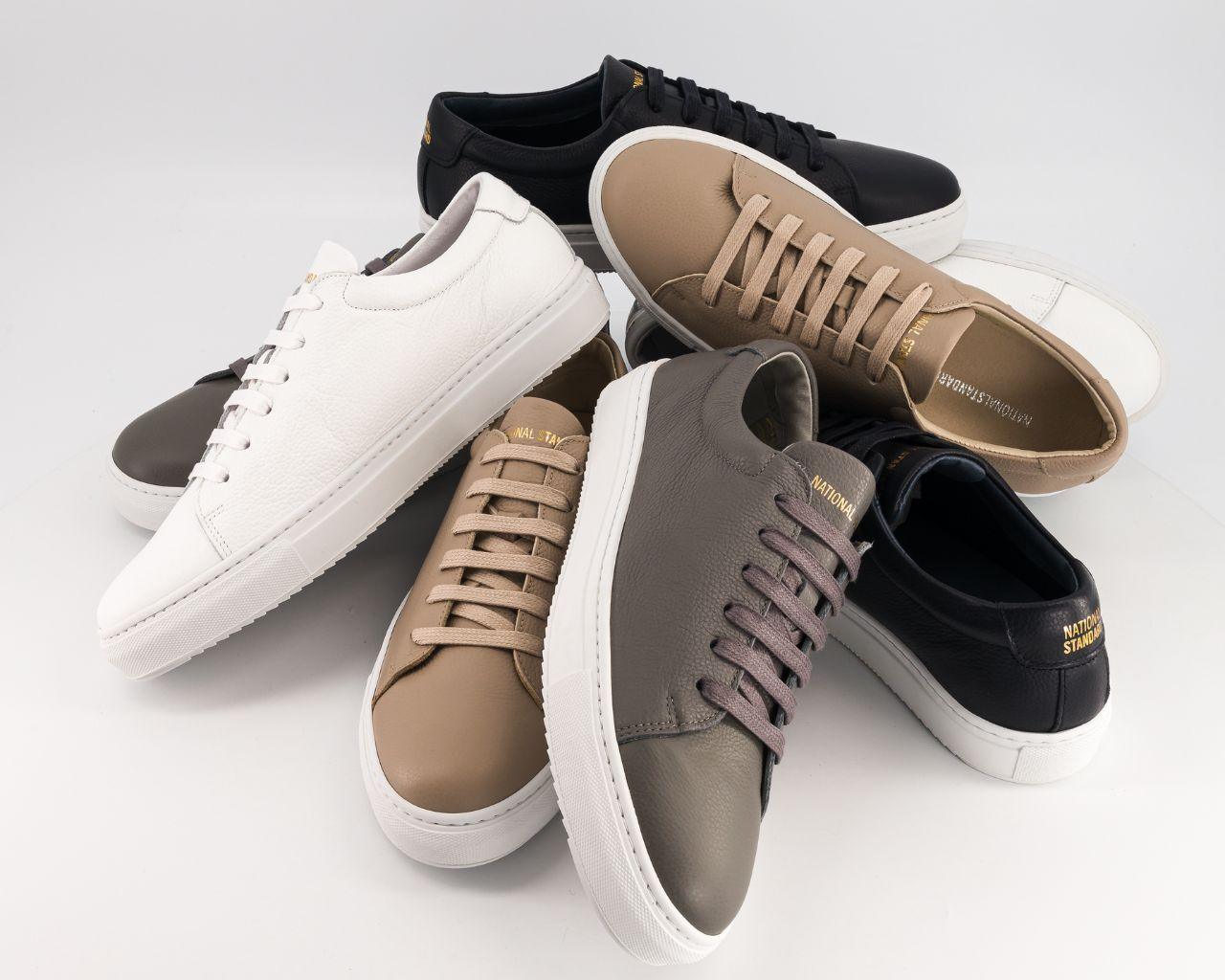 National Standard premium sneakers in assorted neutral colors on white background