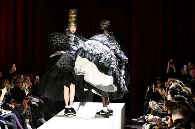 Fashion models in dramatic black-and-white dresses with premium sneakers on runway, National Standard